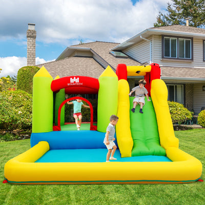 Kids playing on colorful outdoor inflatable bounce house with slide in backyard